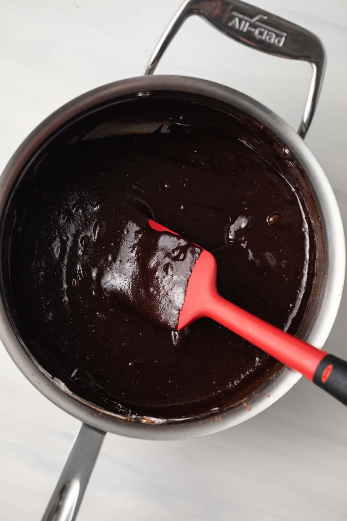 Brownie batter in a saucepan.