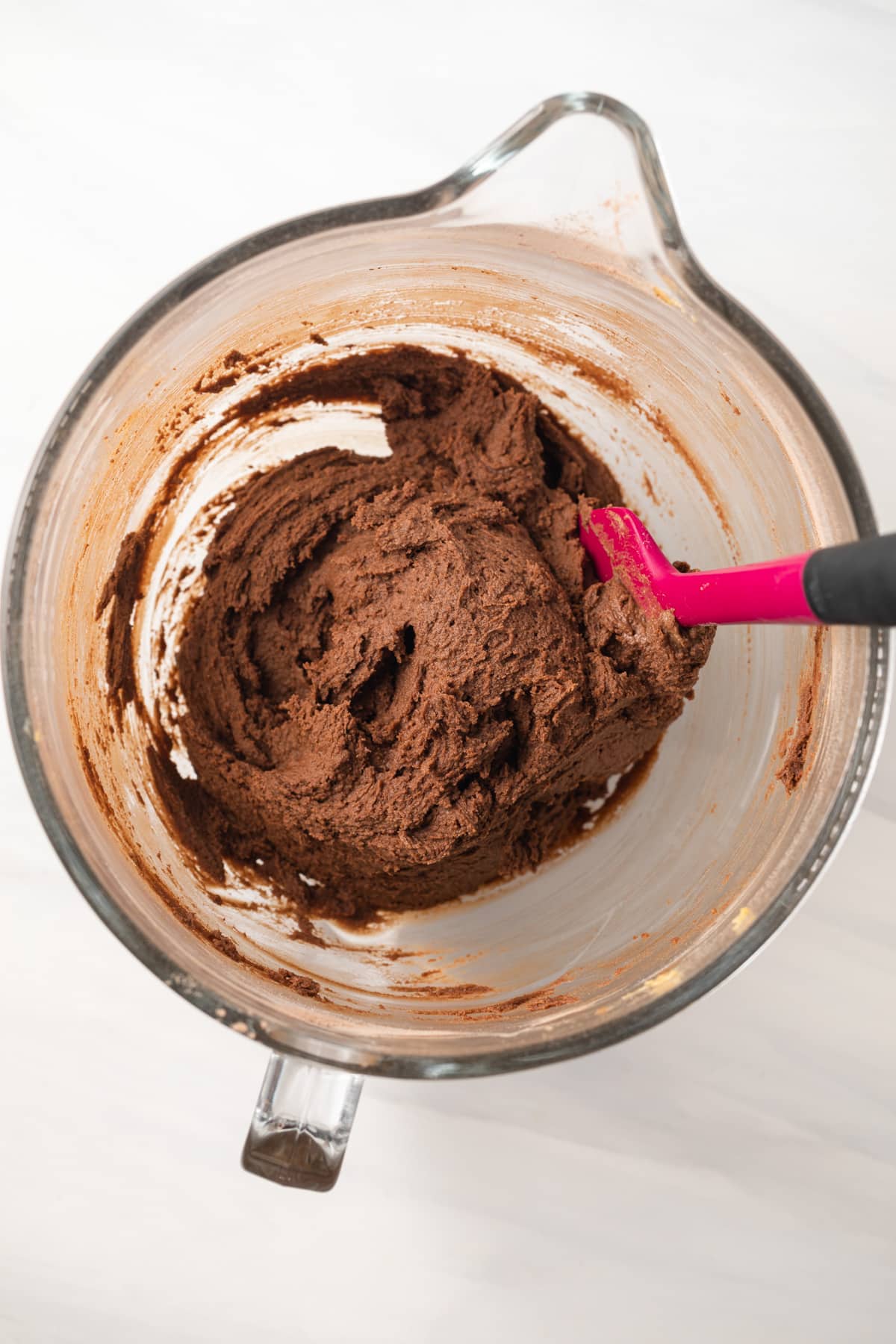 Chocolate peanut butter cookie dough in glass bowl.