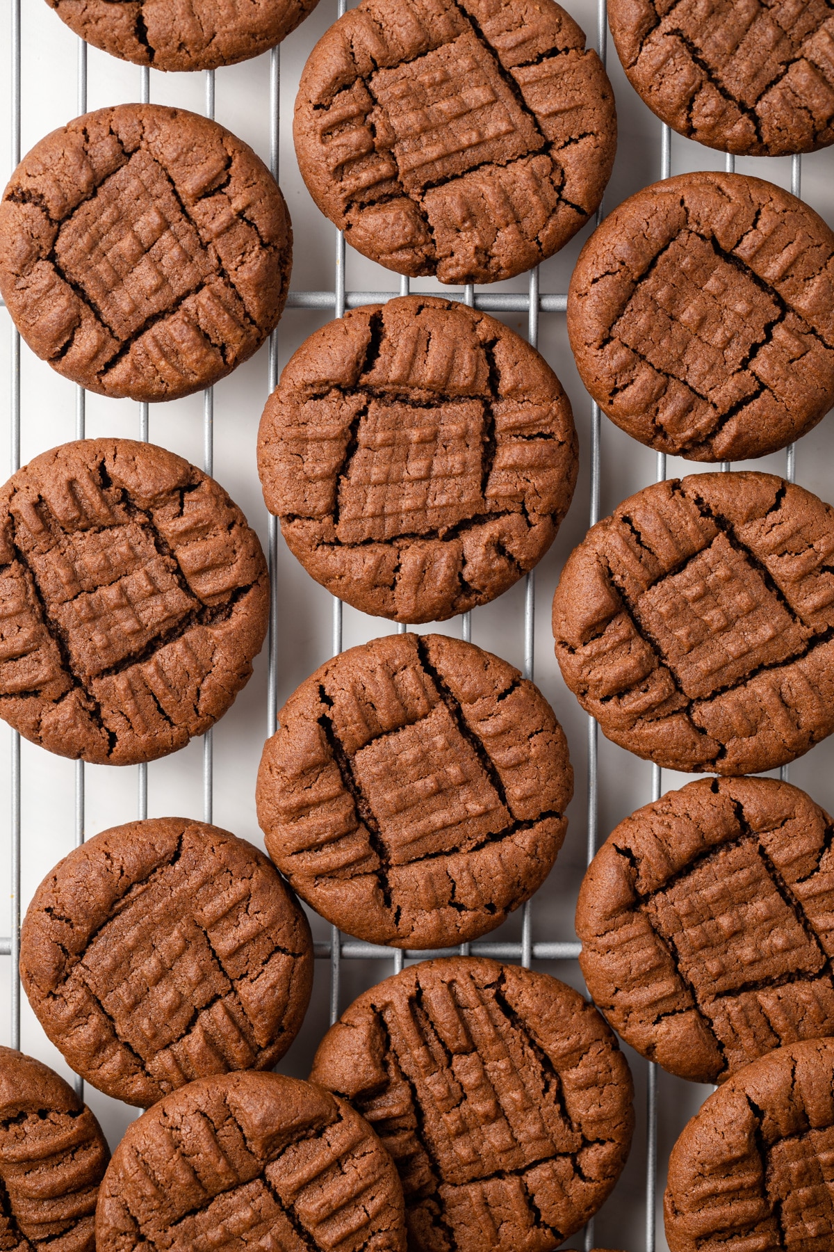 Chocolate peanut butter cookies on wire rack.