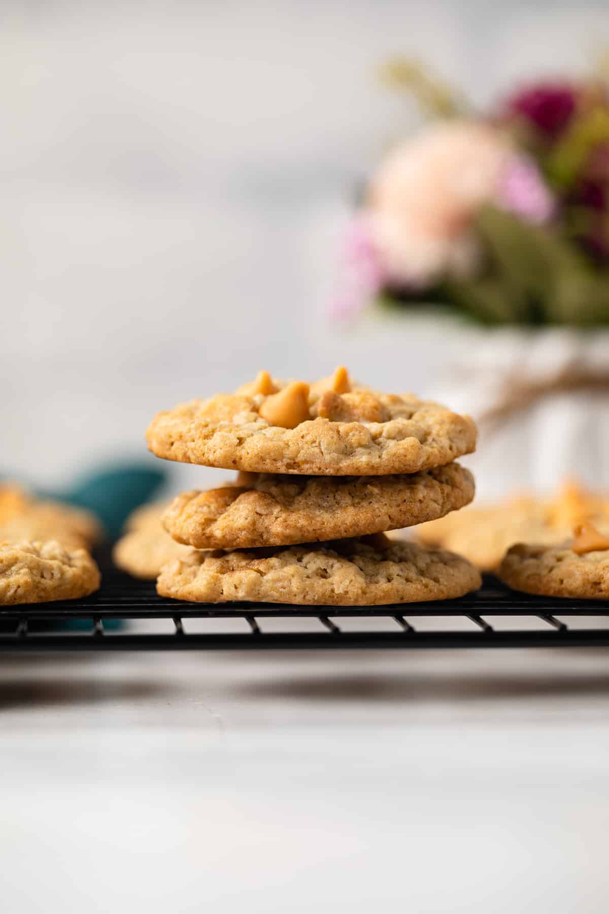 Side view of three oatmeal scotchies on wire rack.