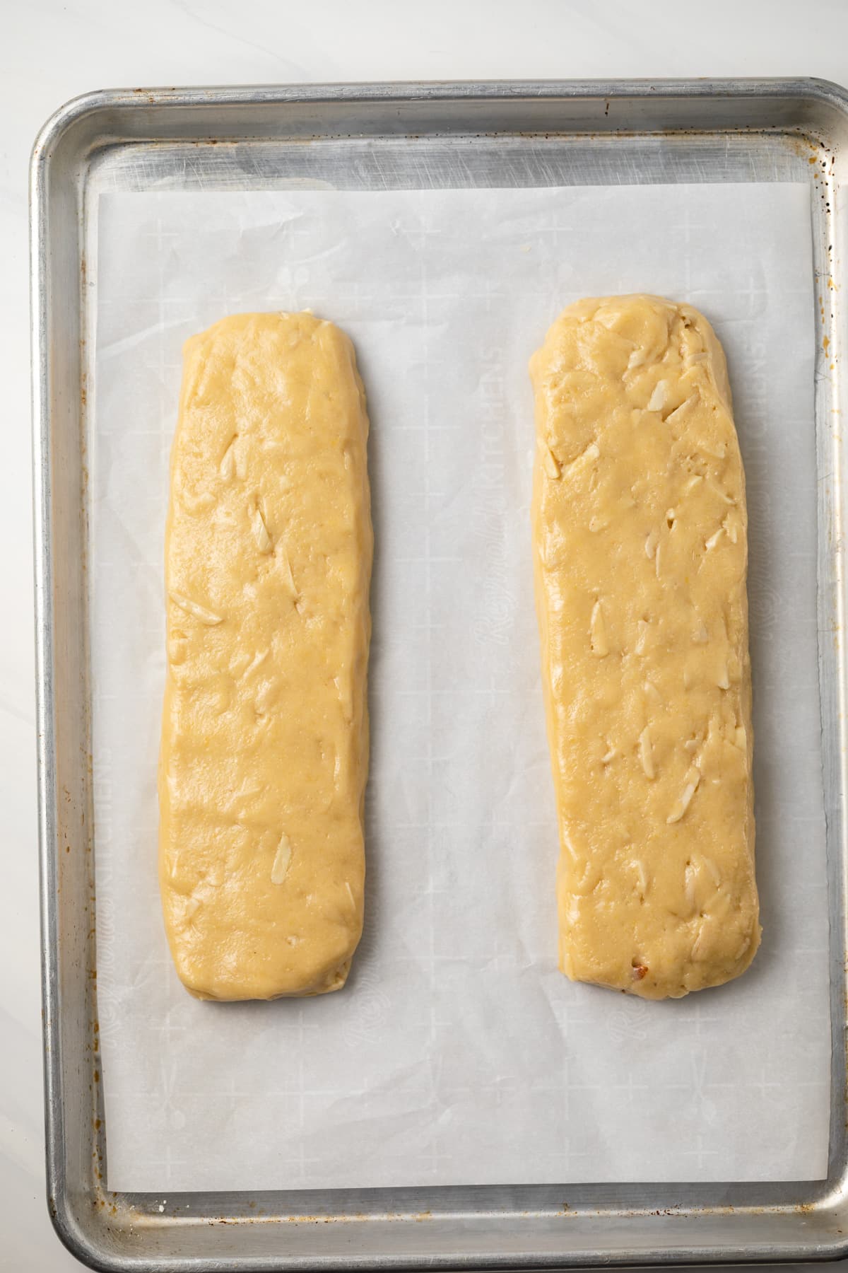 Unbaked almond biscotti on baking sheet.
