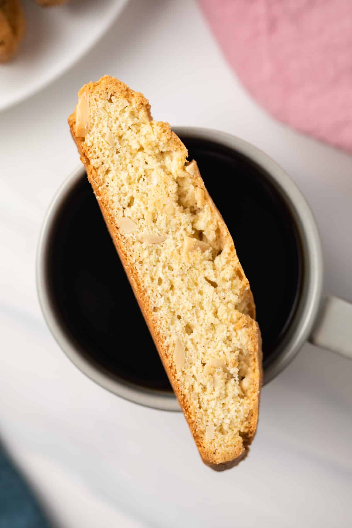 Almond biscotti over cup of coffee.