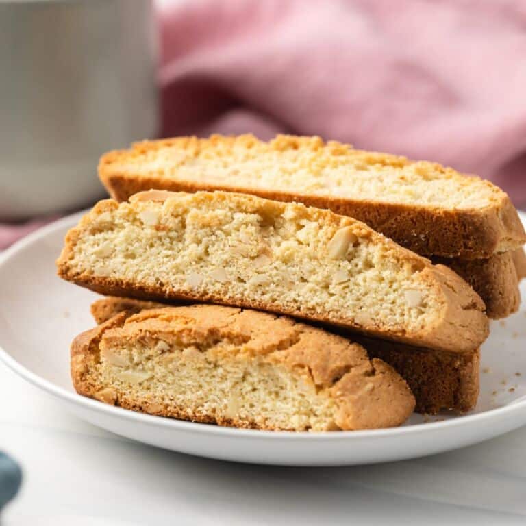 Almond biscotti stacked on plate.