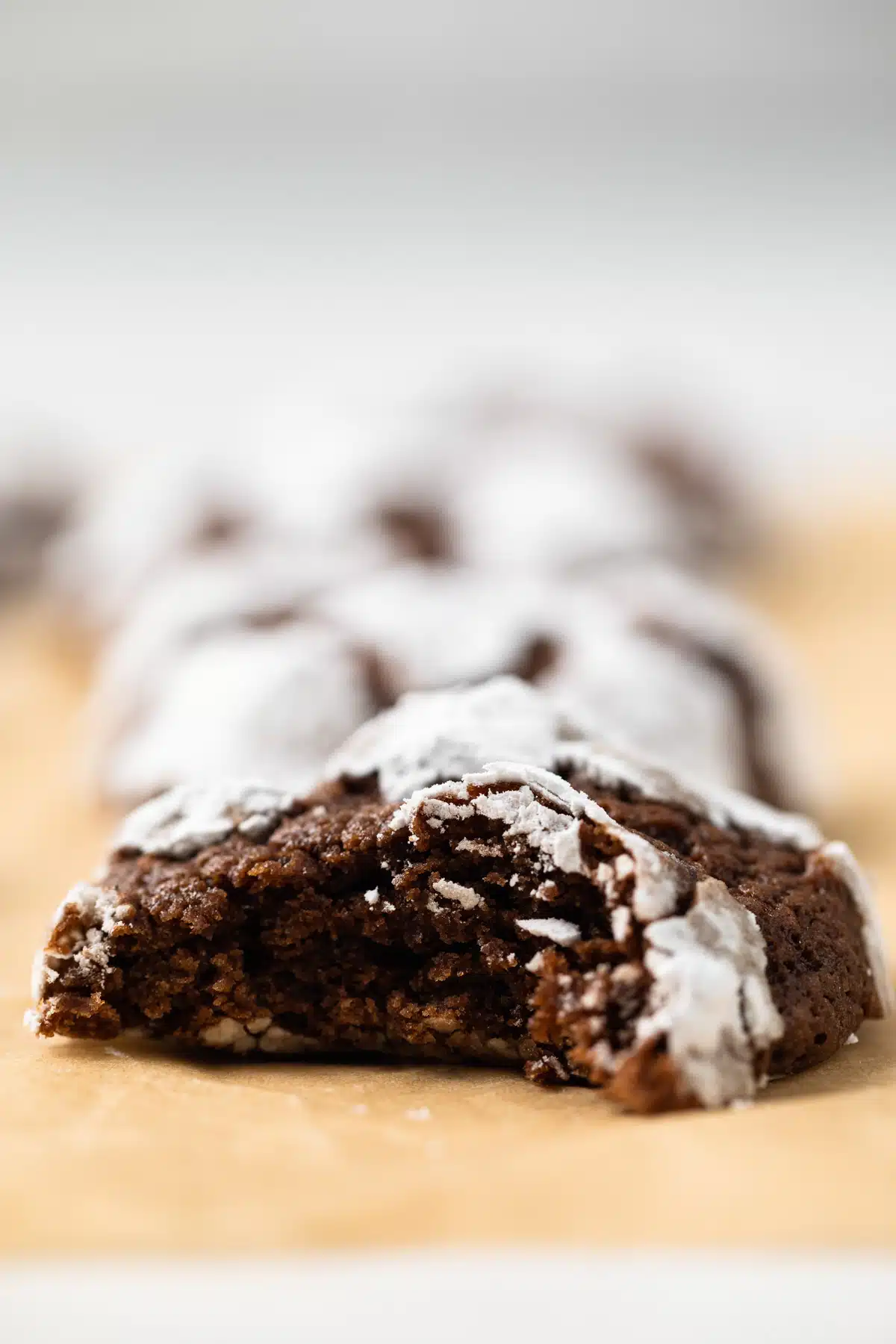 Chocolate crinkle cookie with bite taken out.