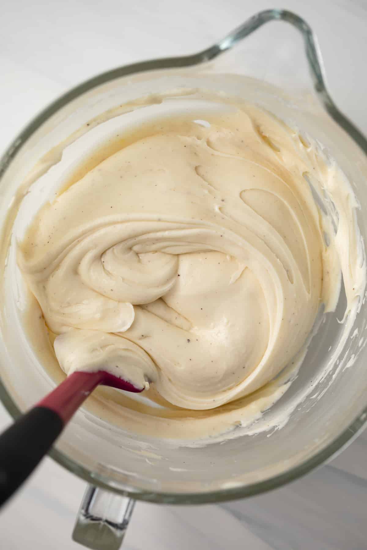 Brown butter cream cheese frosting in glass bowl.
