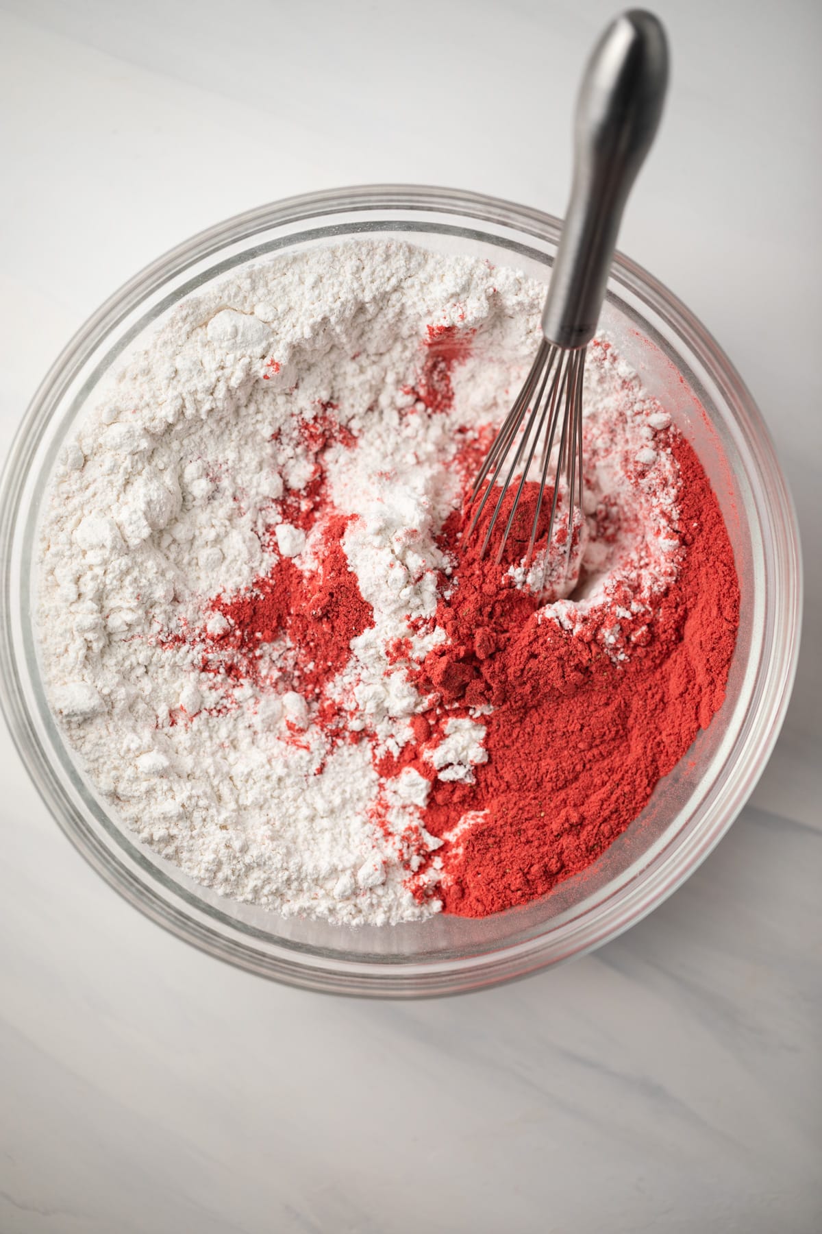 Flour and strawberry powder in glass bowl.