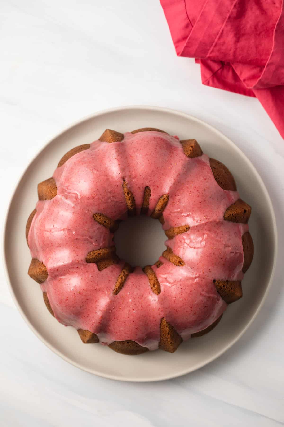 Overhead view of strawberry pound cake on cake plate.
