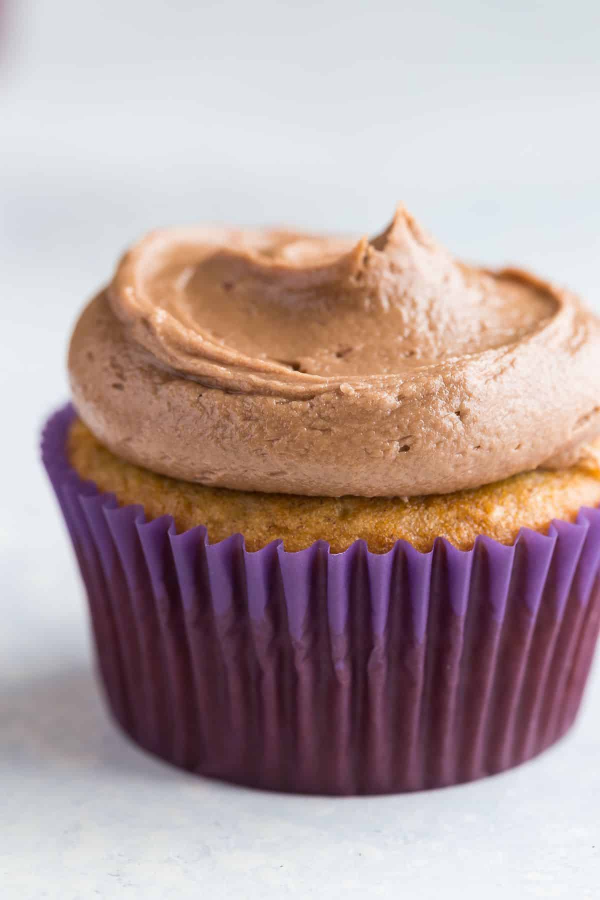 Close up of banana cupcake topped with Nutella frosting.