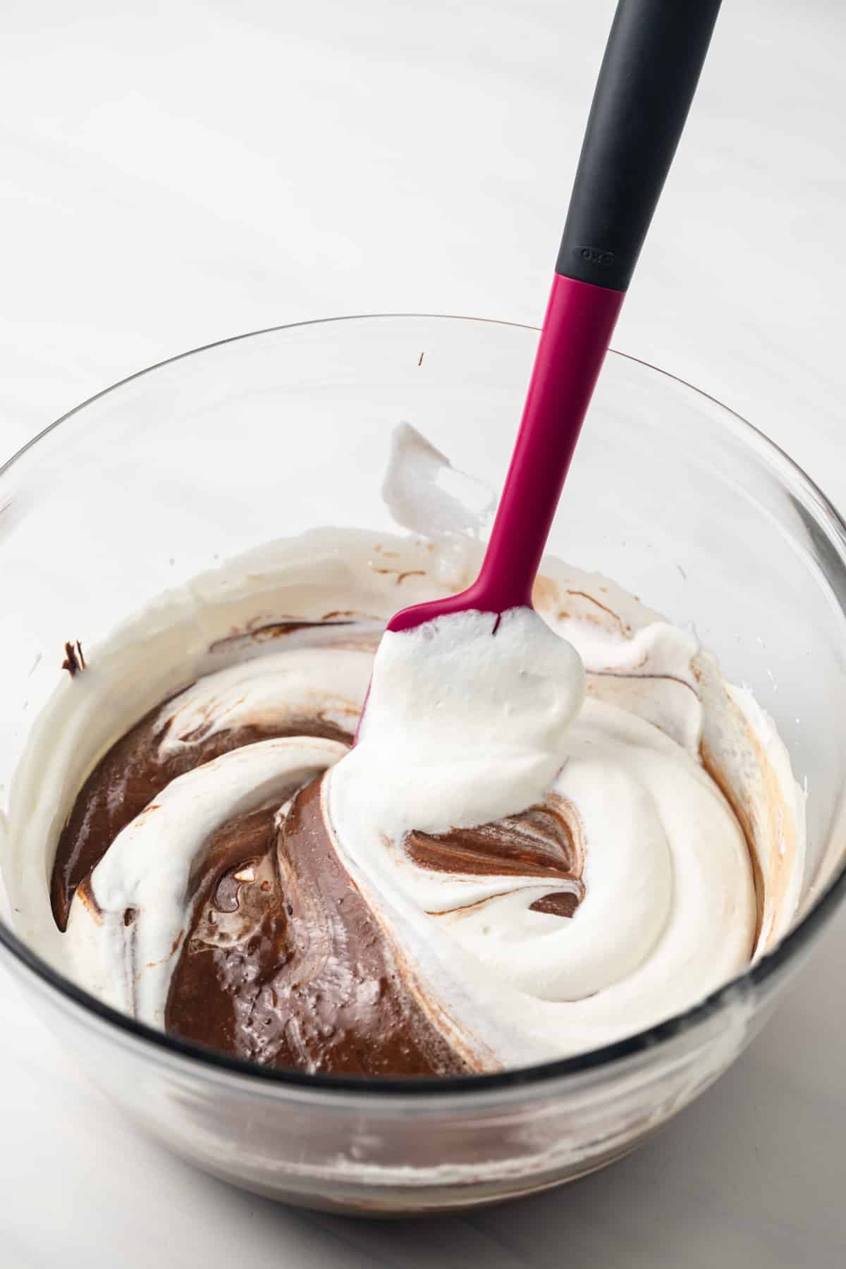 Folding whipped cream into chocolate mixture.