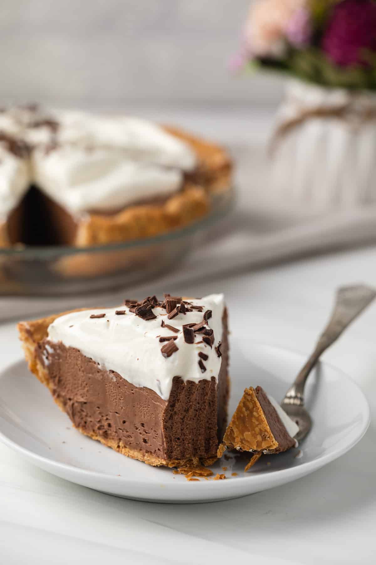 Slice of french silk pie with fork taking out a bite.
