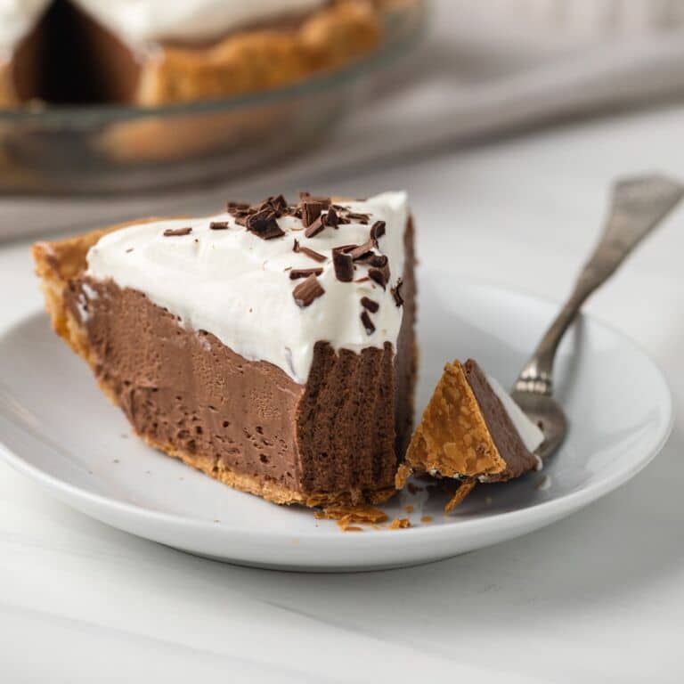 Slice of french silk pie with fork taking out a bite.