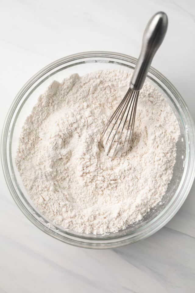 Flour in mixing bowl with whisk.