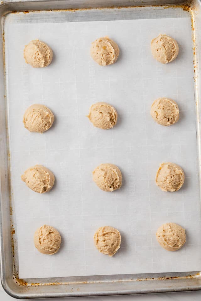 Unbaked banana cookies on a baking sheet.