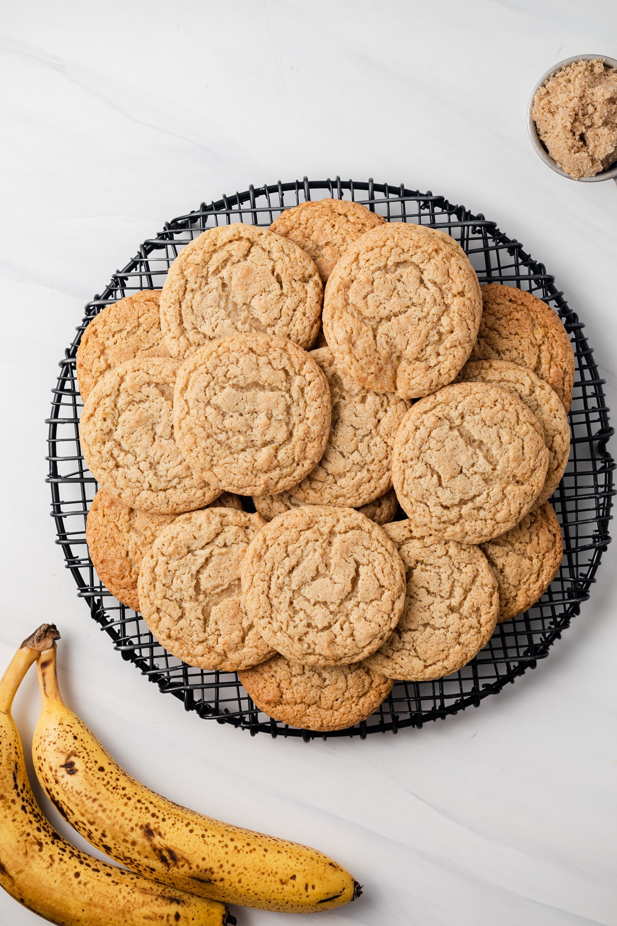 Overhead of banana cookies on a wire rack.