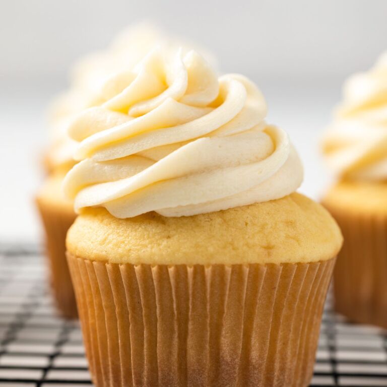 Vanilla cupcakes topped with ermine frosting.