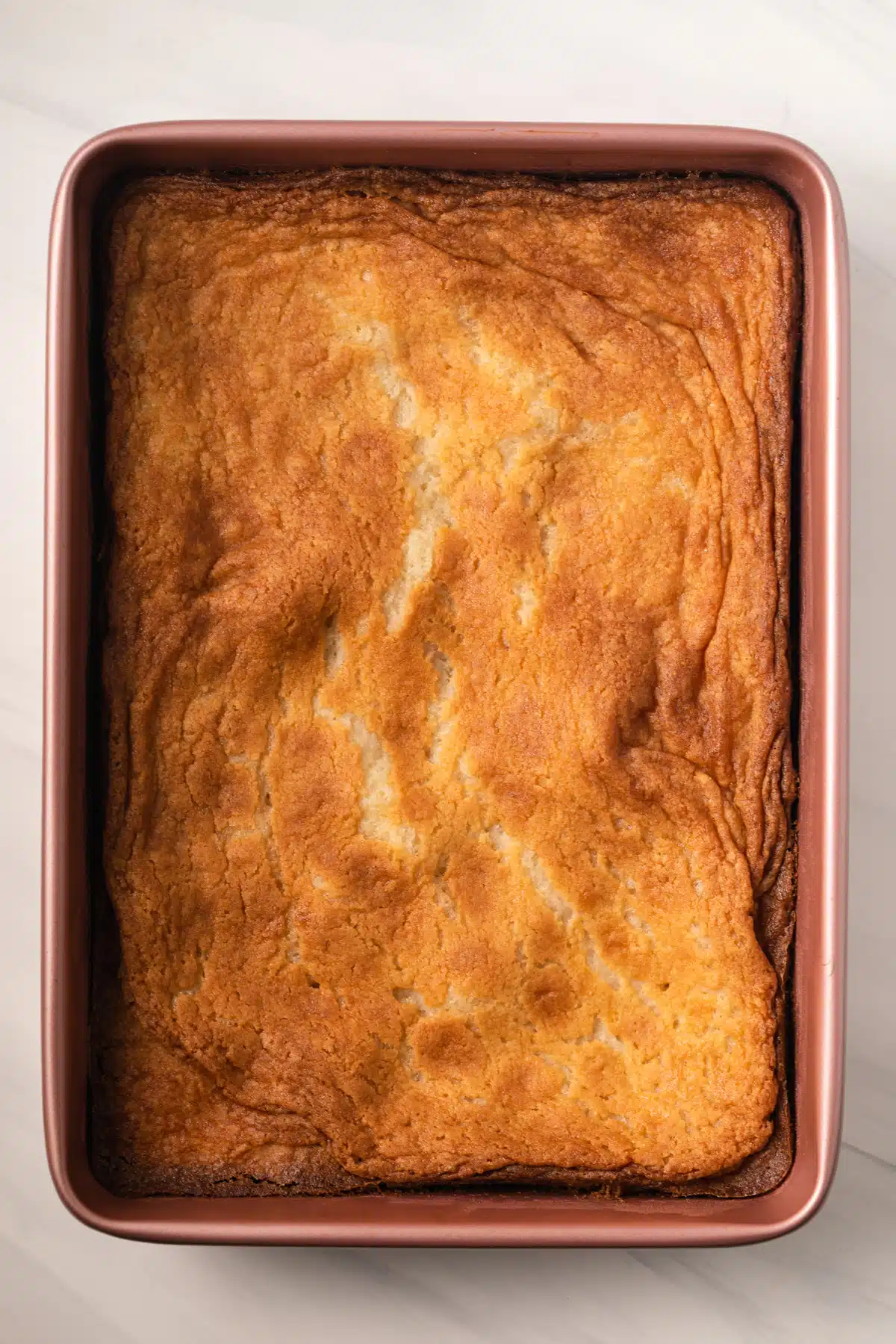 Gooey butter cake in a cake pan.