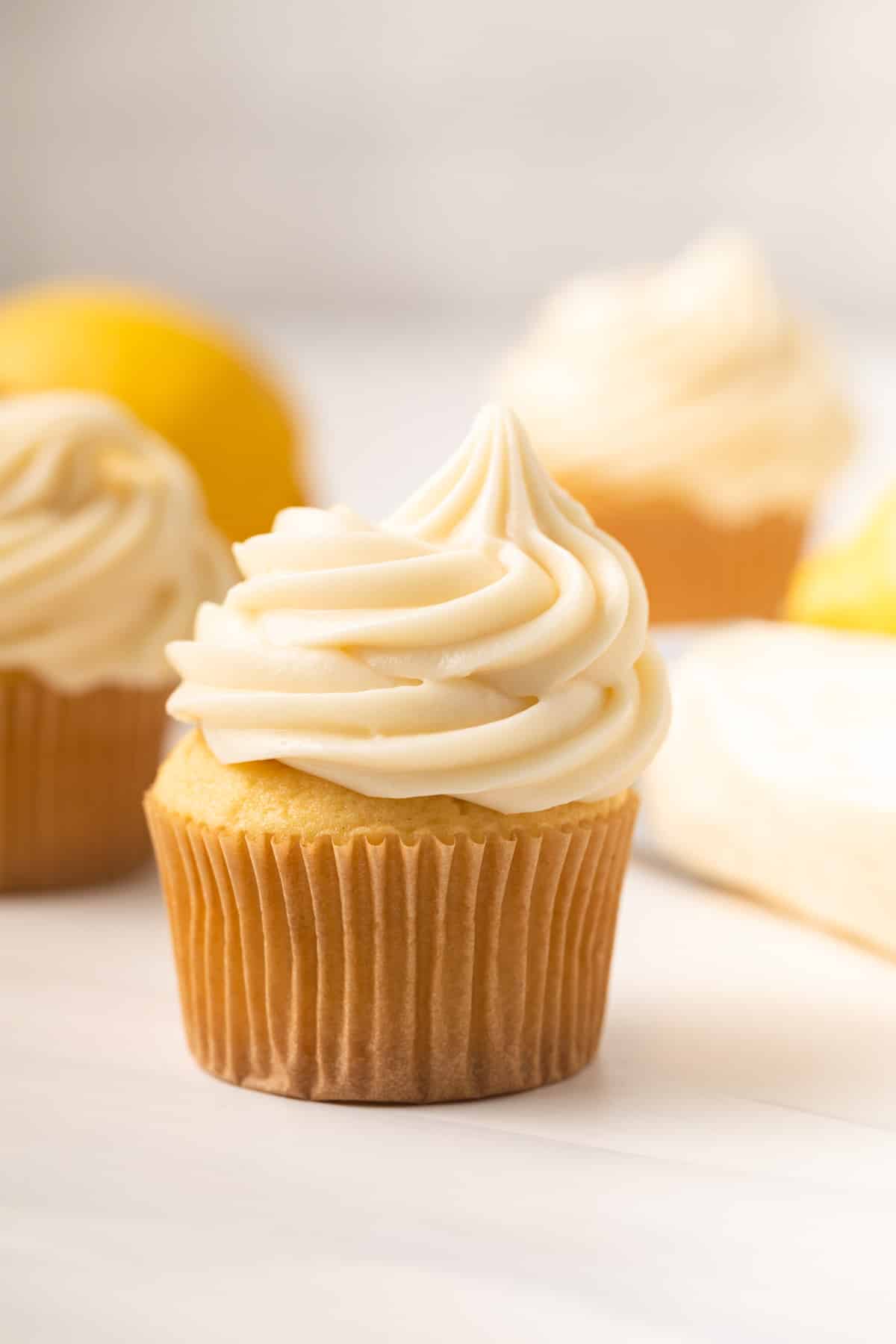 Lemon cream cheese frosting swirled in top of a cupcake.
