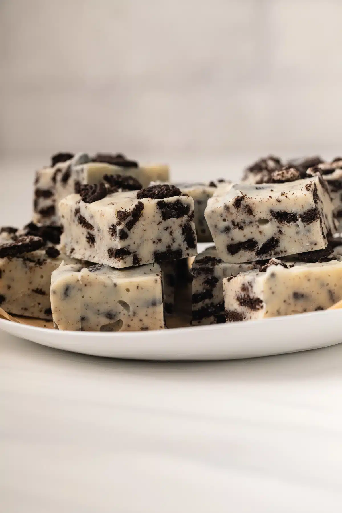 Oreo fudge stacked on white plate.