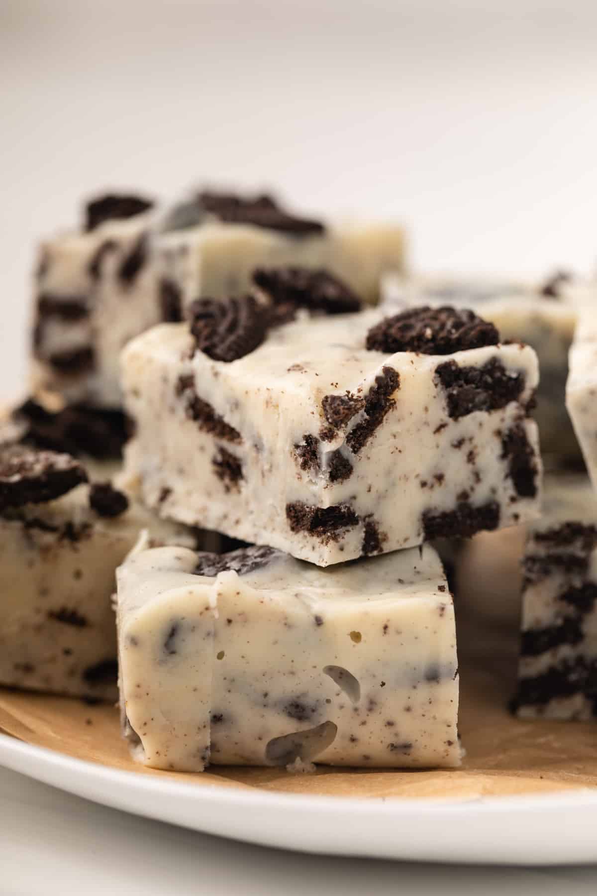 Close up of oreo fudge stacked on white plate.
