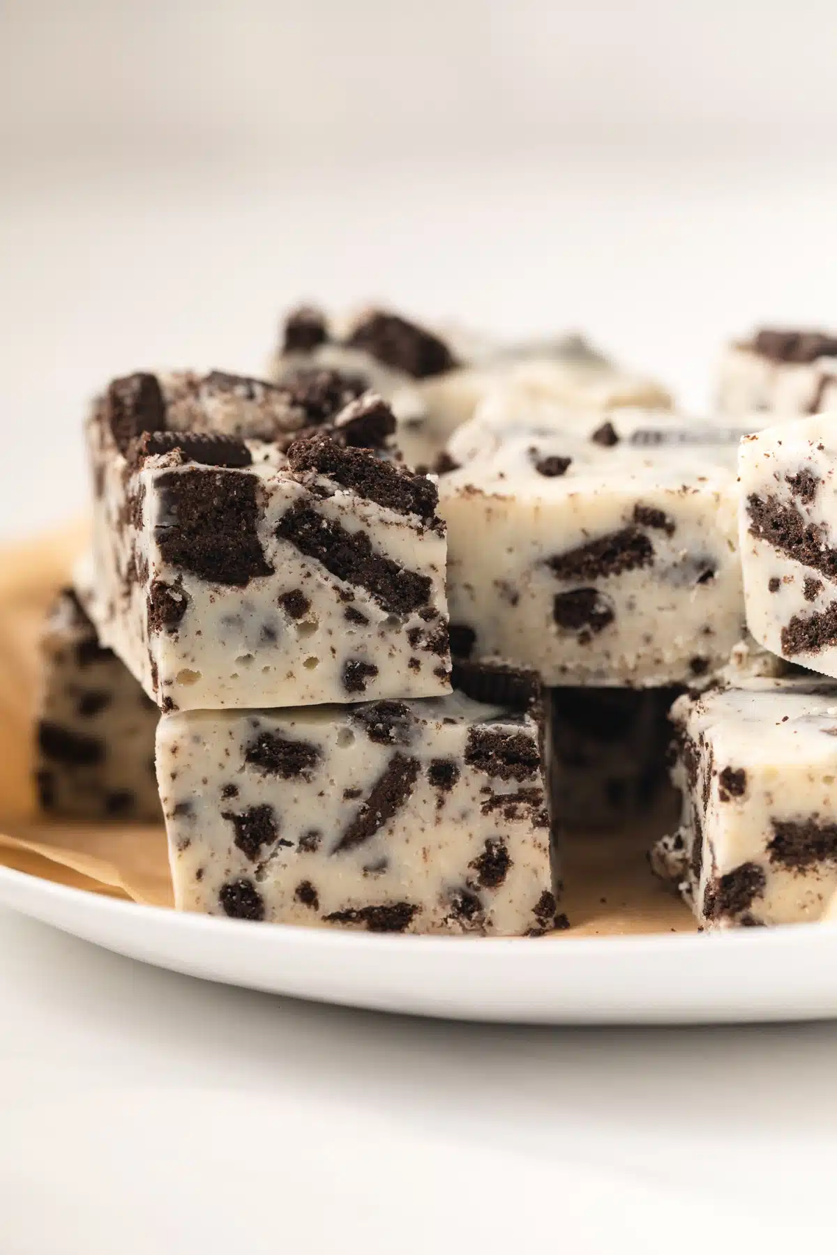 Oreo fudge stacked on white plate.