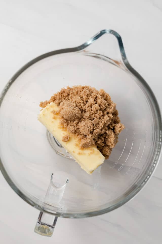 Butter and brown sugar in a glass bowl.