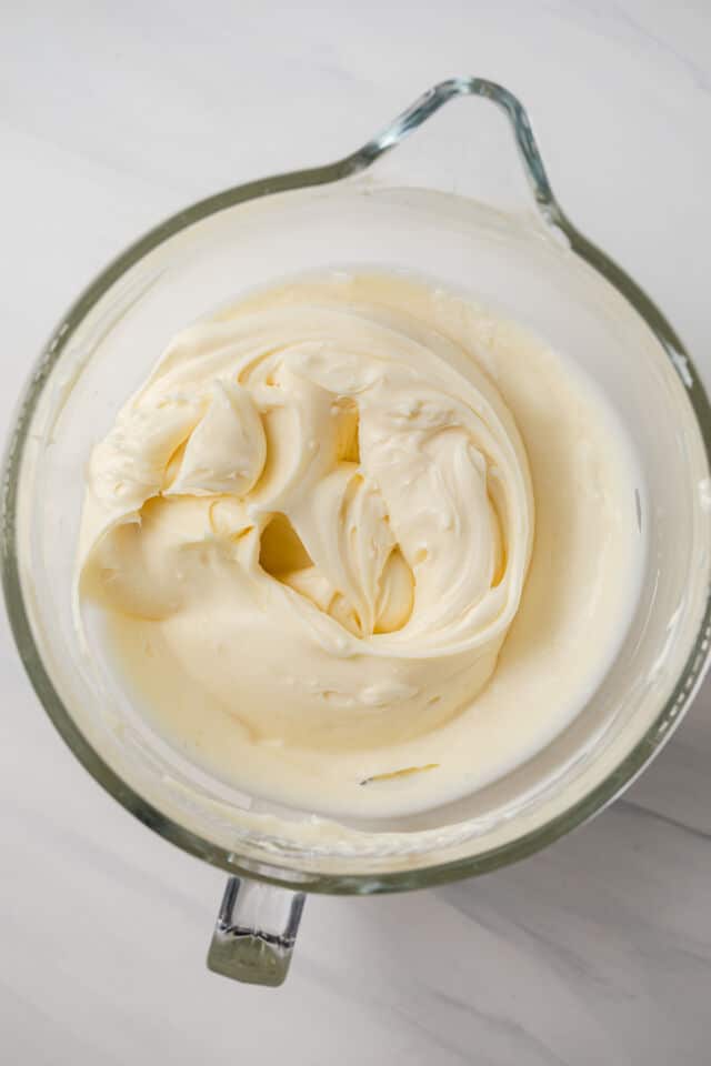 Cream cheese and mascarpone mixed in a glass bowl.