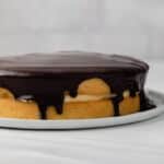 Boston cream pie on white plate.