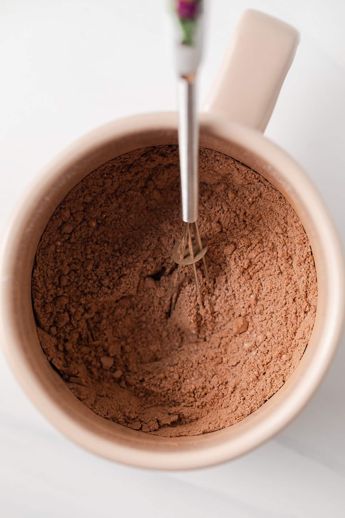 Dry ingredients for brownies in a mug.