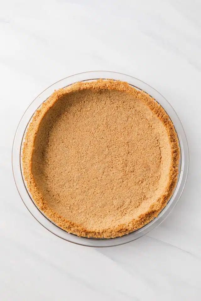 Graham cracker crust in glass pie dish.