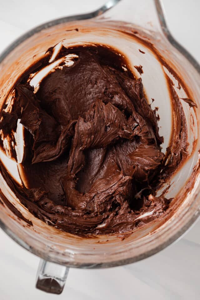 Chocolate fudge frosting in a mixing bowl.