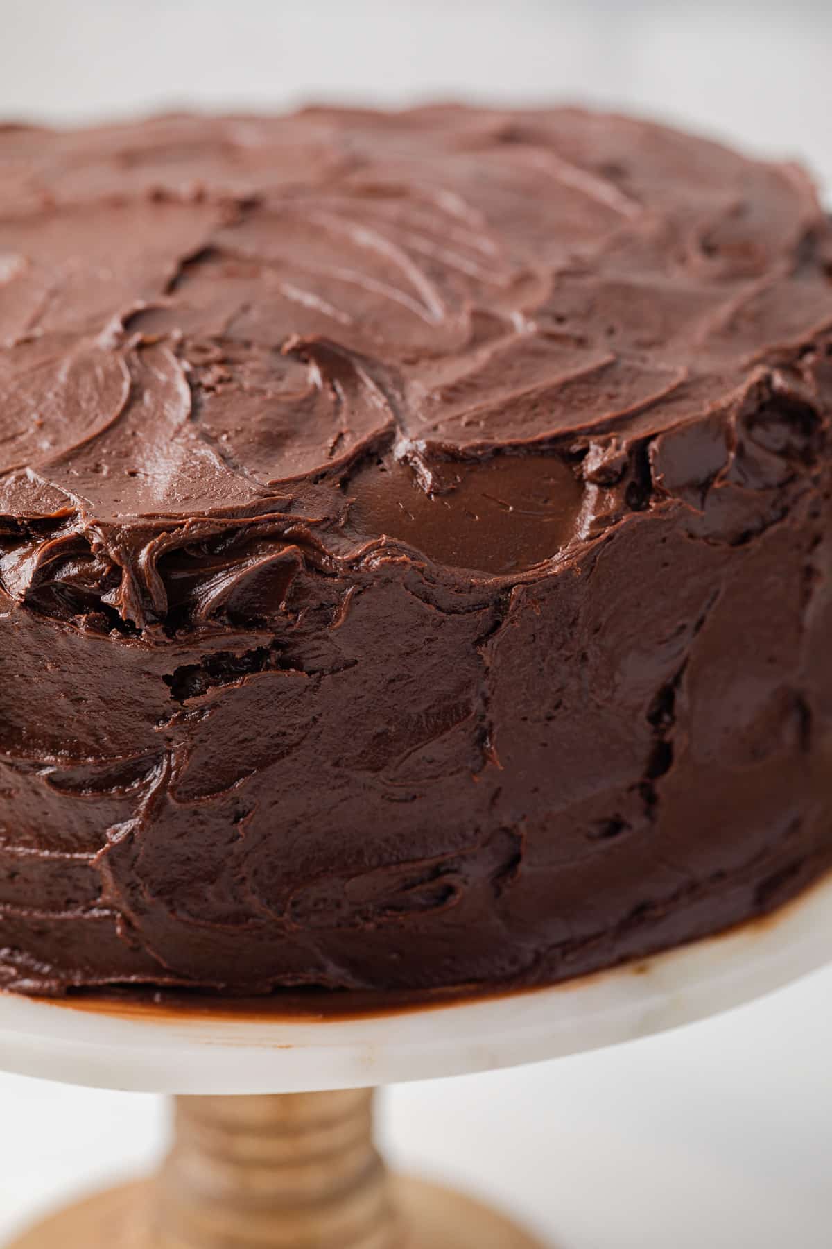 Close up of fudge frosting on a cake.