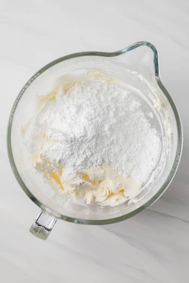 Cream cheese and powdered sugar in mixing bowl.