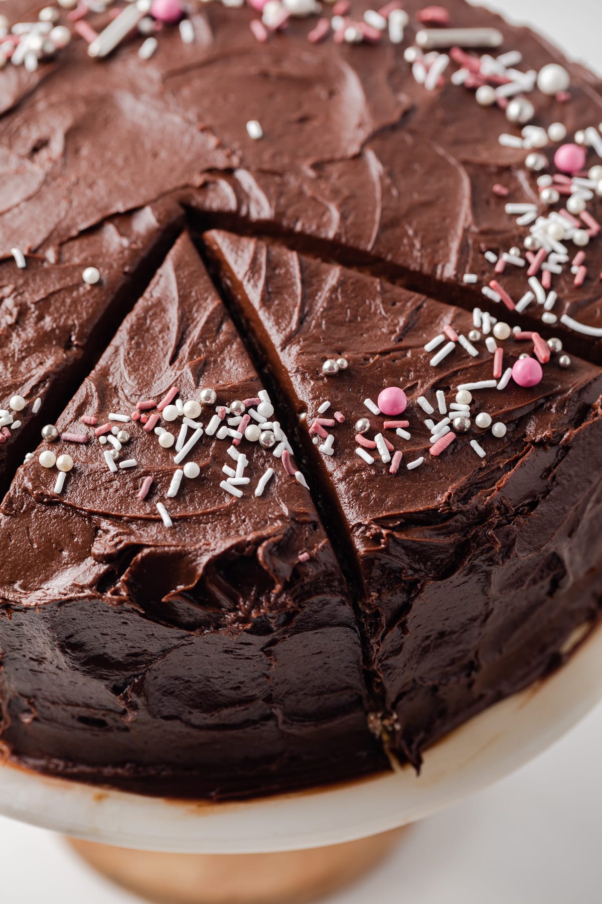 Close up of yellow cake with chocolate frosting sliced.