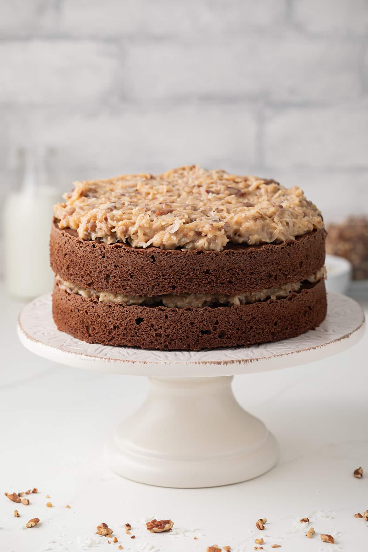 Side view of German chocolate cake on cake stand.