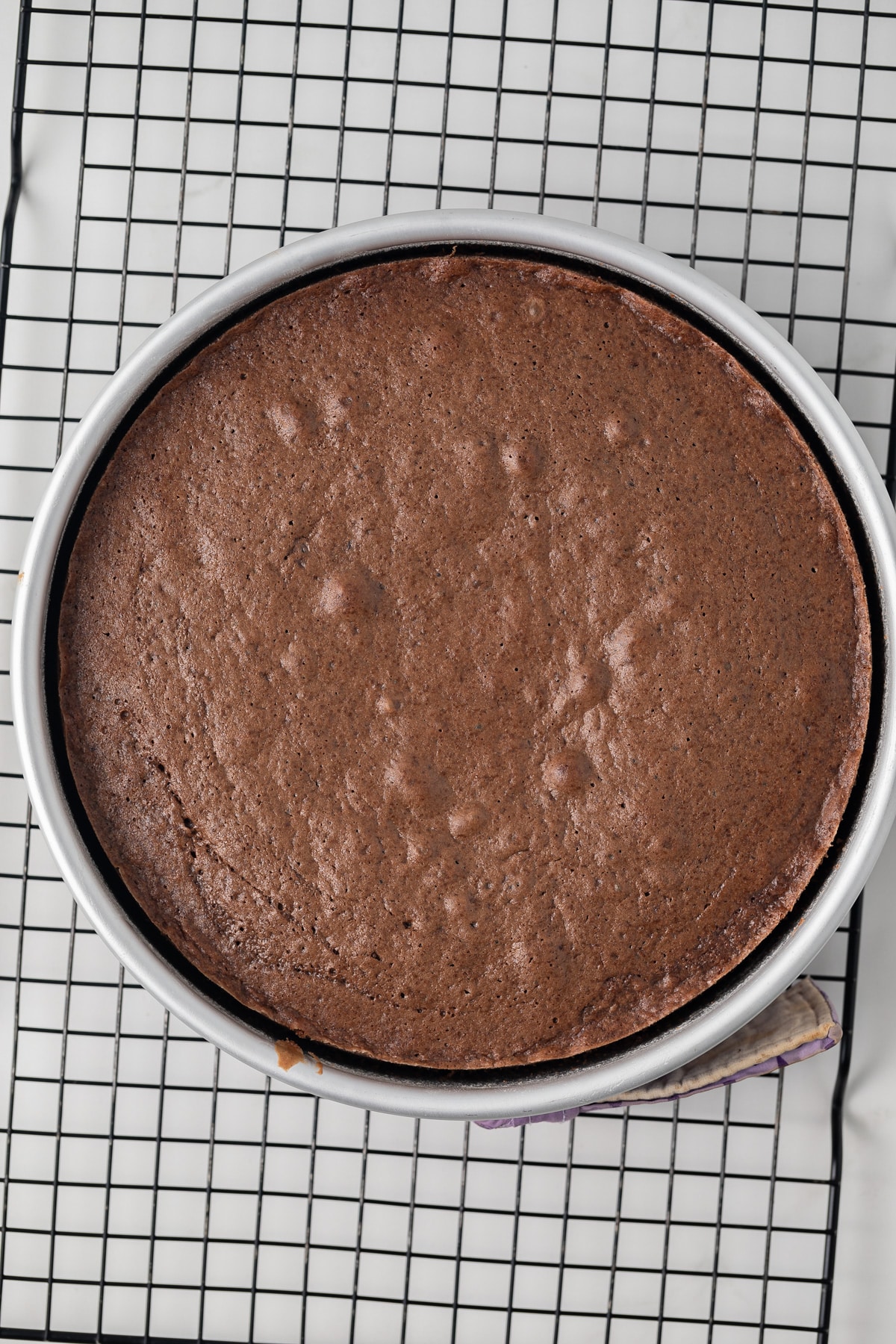 Chocolate cake layer in cake pan.