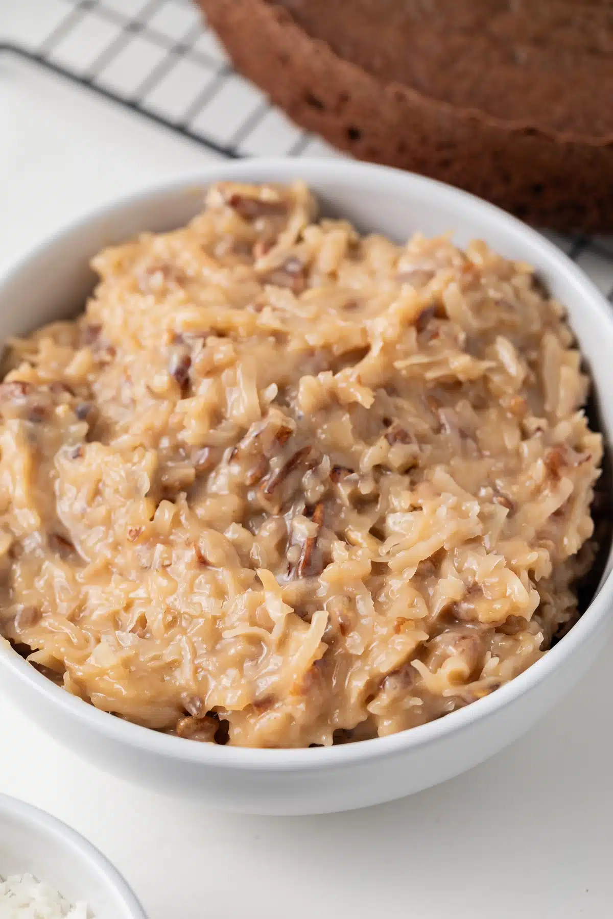 German chocolate cake frosting in white bowl.