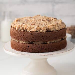 Side view of German chocolate cake on cake stand.