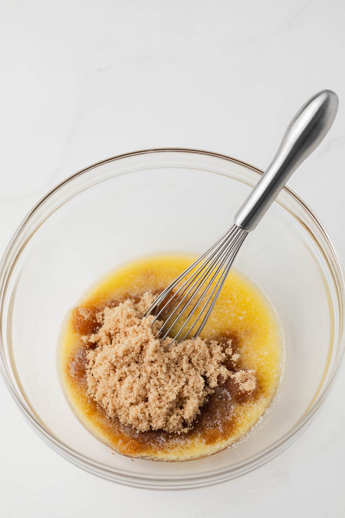 Brown sugar and butter in glass mixing bowl.