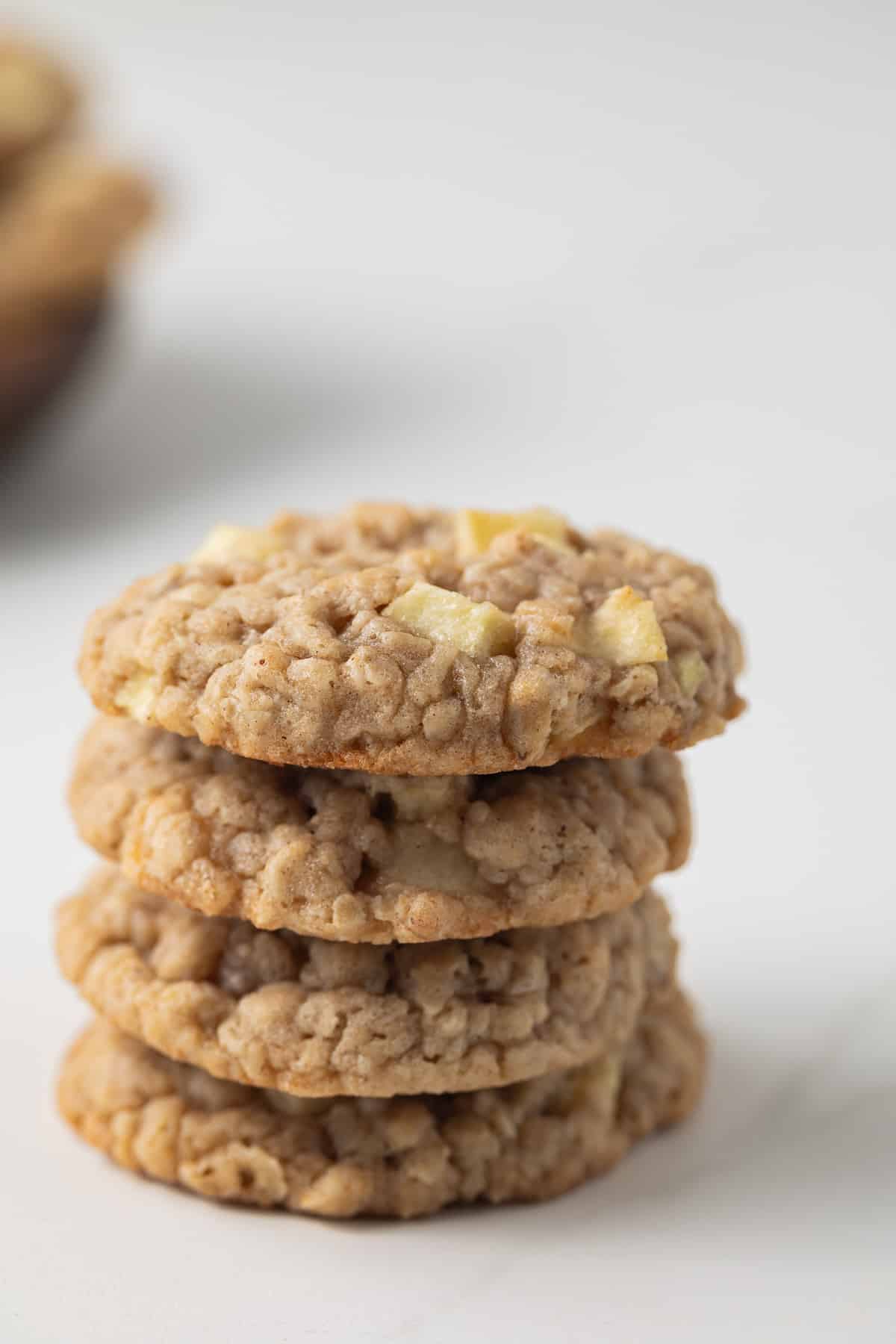 Apple oatmeal cookies stacked four high.