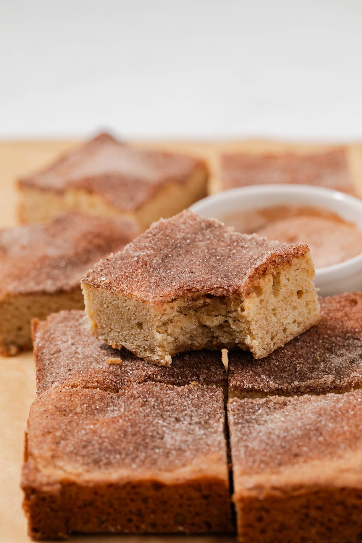 Snickerdoodle blondies with a bite taken out of one.