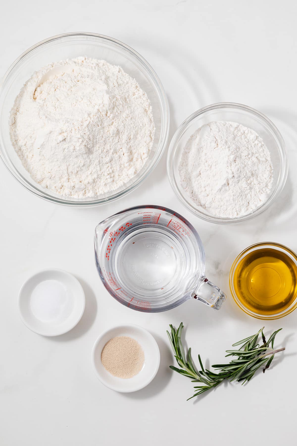 Ingredients for focaccia bread in bowls.