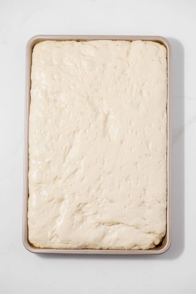 Proofed dough in baking pan.