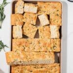 Sliced focaccia in baking pan.