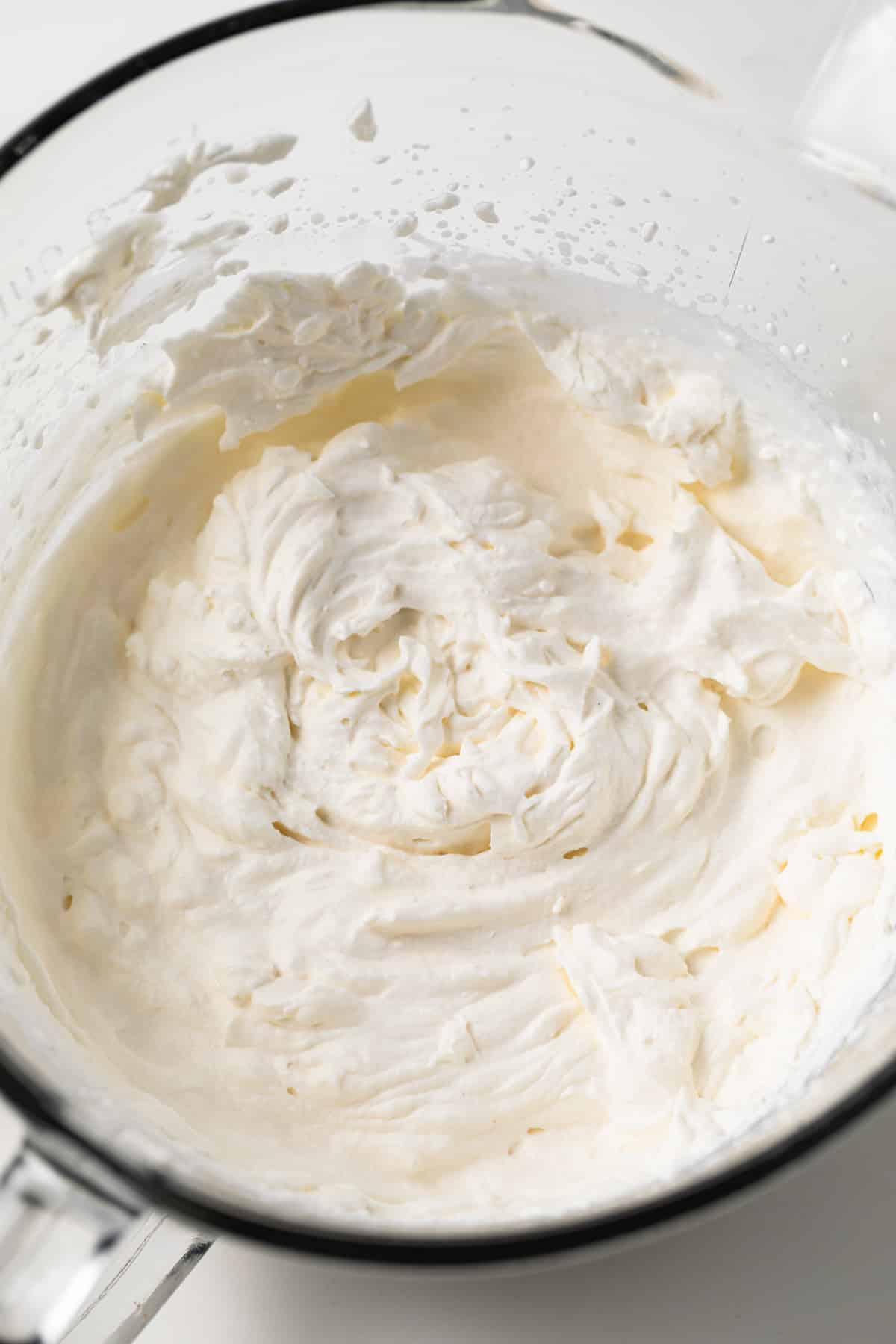 Whipped cream in glass bowl.