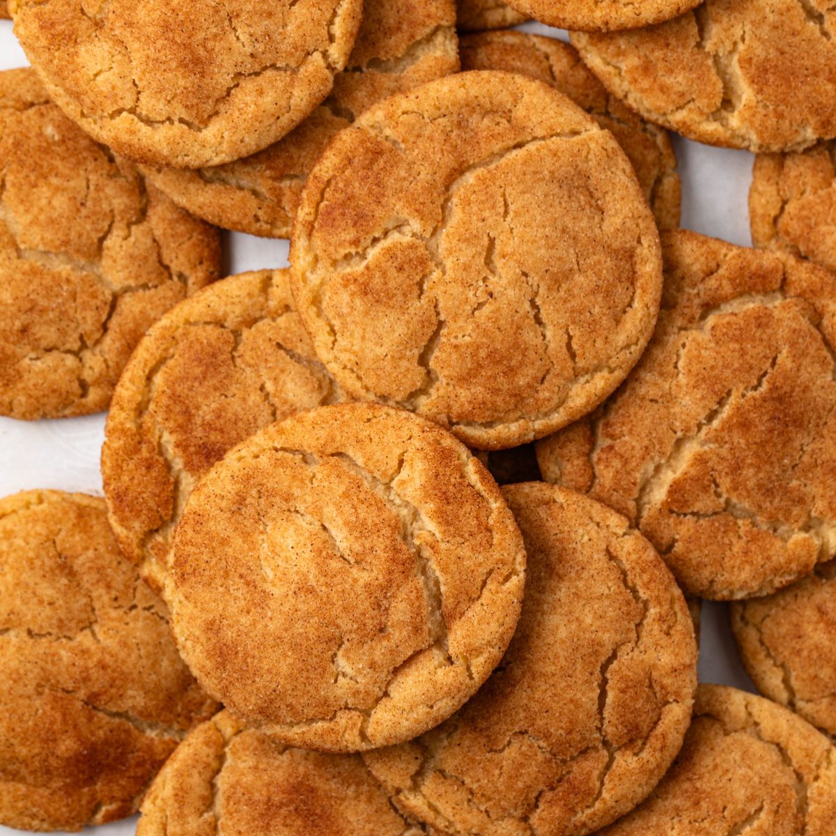 Brown butter snickerdoodles scattered on baking pan.