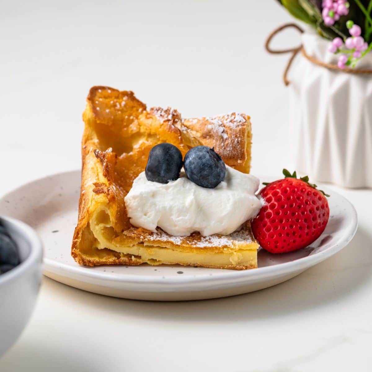 Slice of German pancake on plate.