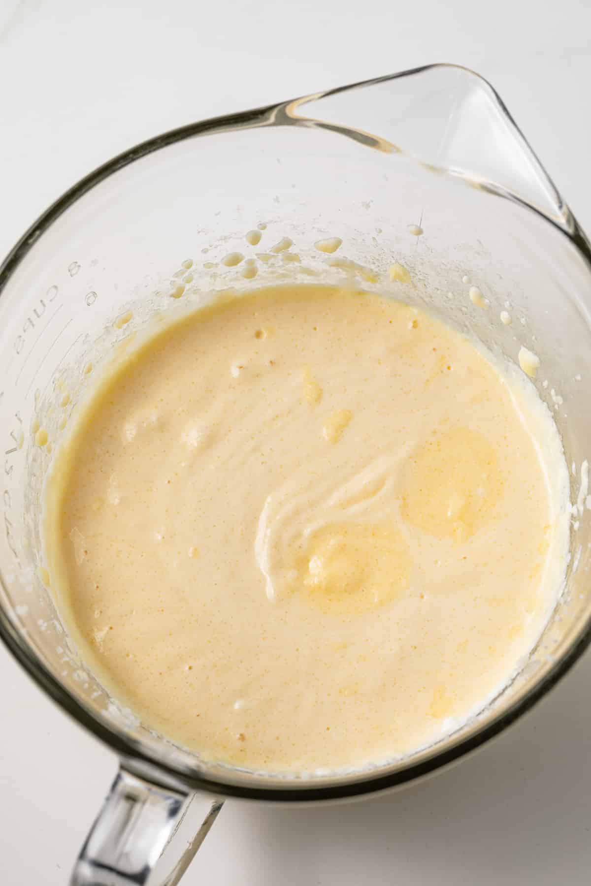 Wet ingredients blended in a glass bowl.