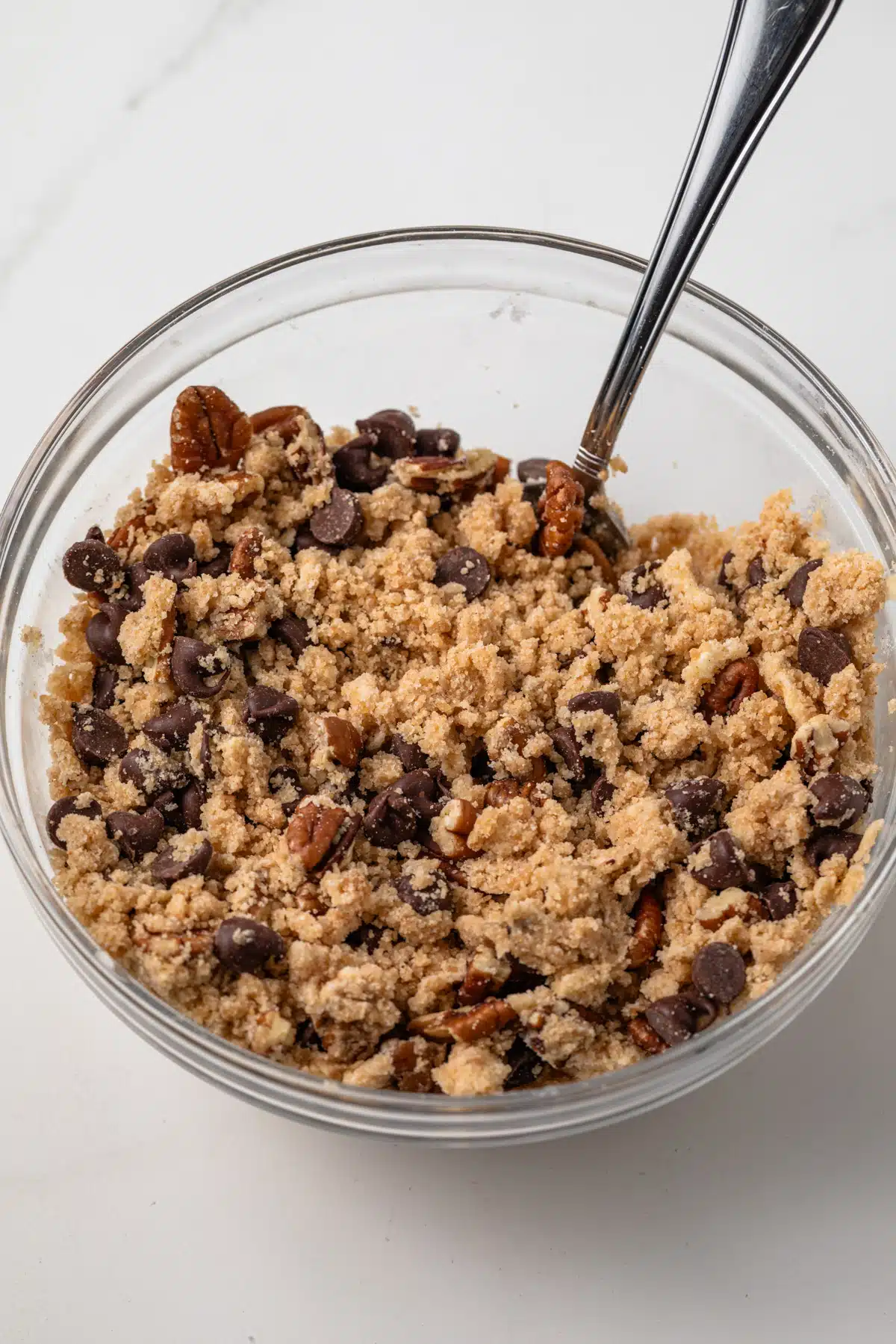 Chocolate chip pecan crumb topping in a glass bowl.