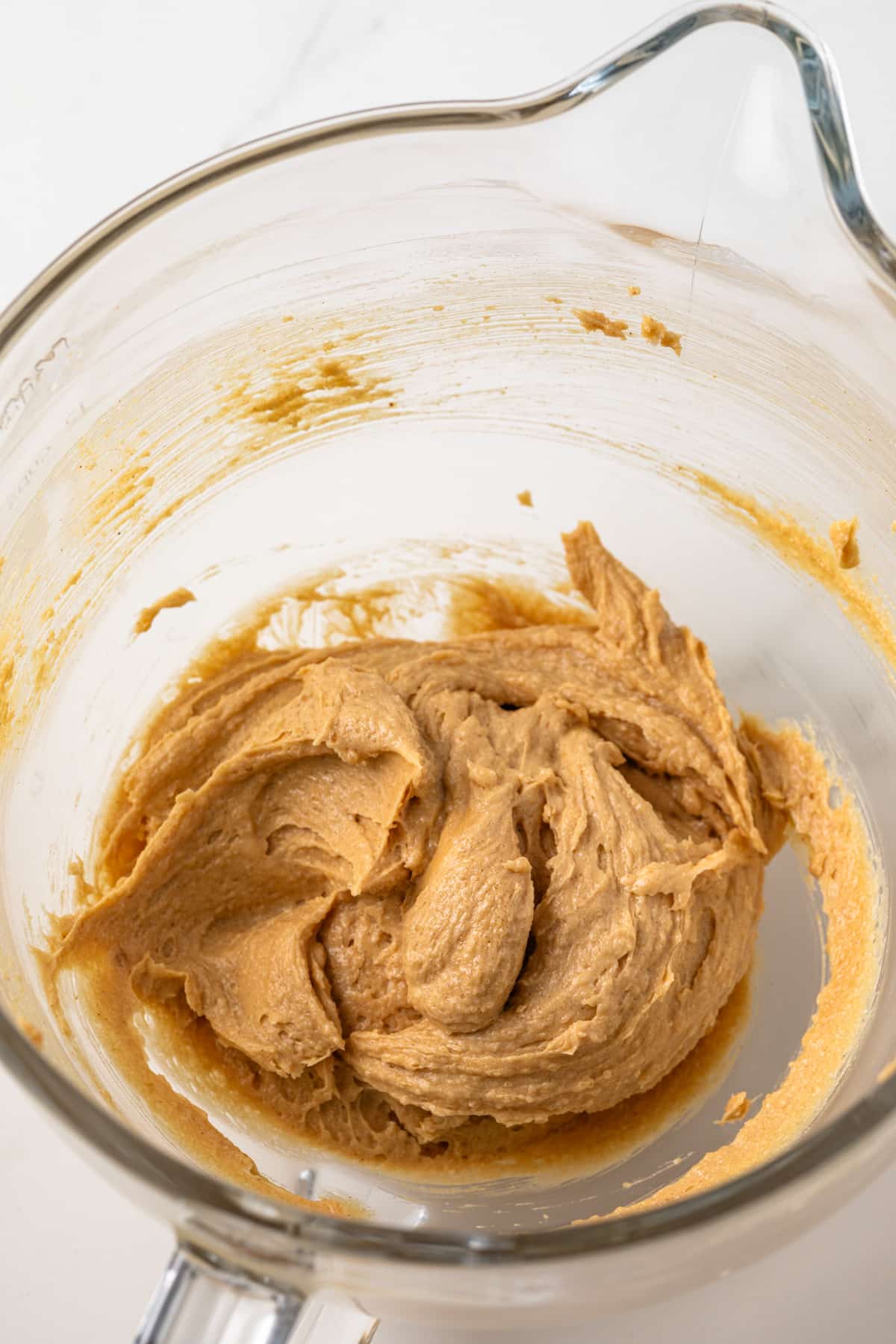 Wet ingredients mixed in a glass bowl.
