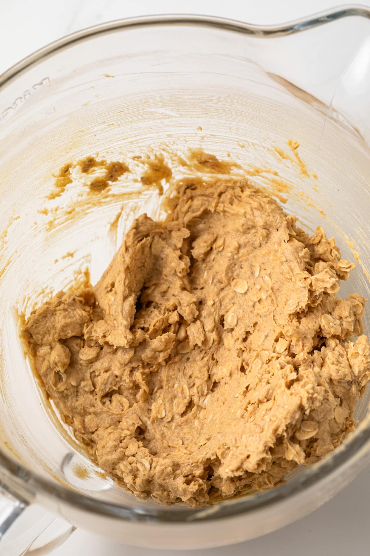Wet and dry ingredients mixed in a glass bowl.